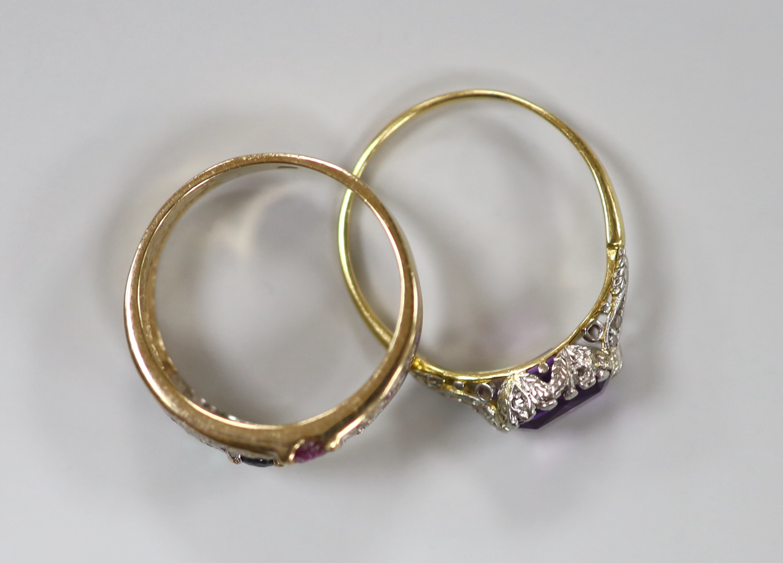 A yellow metal, and single stone amethyst set ring, with diamond chip set shoulders, size O and a yellow metal and cubic zirconia cluster set ring, gross weight 5.2 grams.